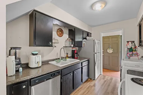 a kitchen with refrigerator and stove