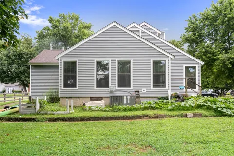 a front view of a house with a yard and porch
