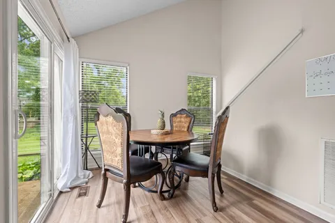 a view of a dining room with furniture and wooden floor