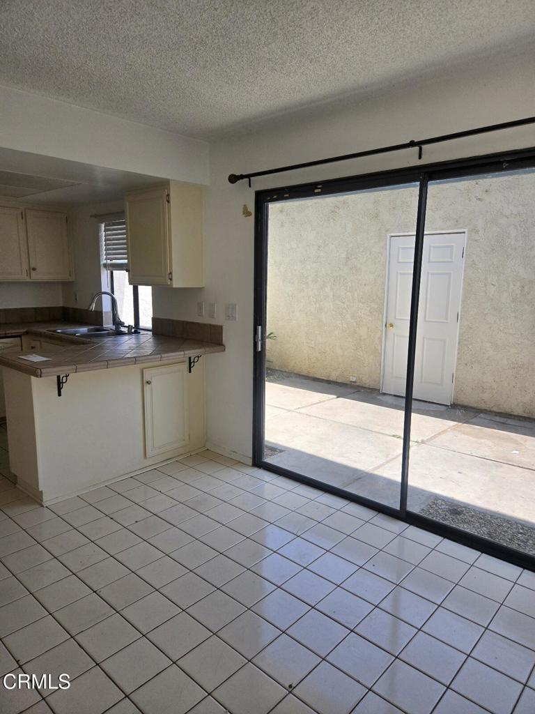 2065 East Bard Road Oxnard, CA 93033 - Photo 5 of 18 a kitchen with a sink a refrigerator and cabinets