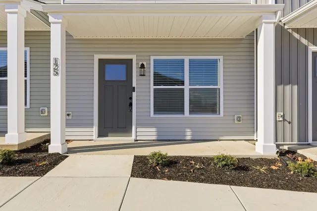 a view of empty room with wooden floor and ceiling fan