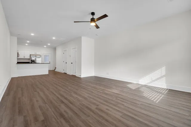 a view of kitchen with wooden floor and electronic appliances
