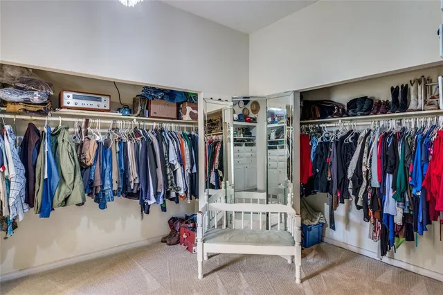 a view of walk in closet with clothes