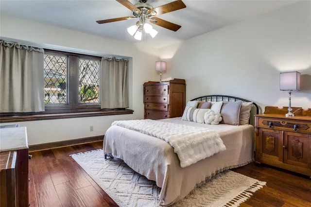 a bedroom with a large bed and a large window