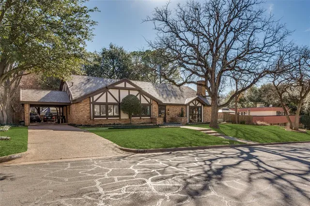 a tree in front of a white house
