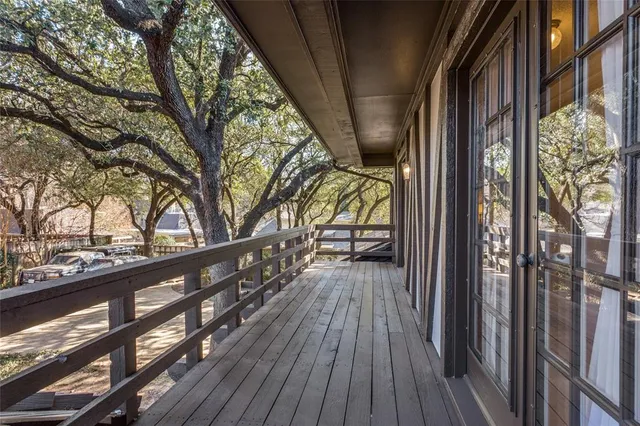 a view of balcony with wooden floor and fence