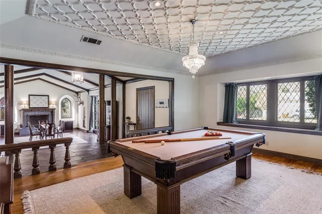 a room with pool table and windows