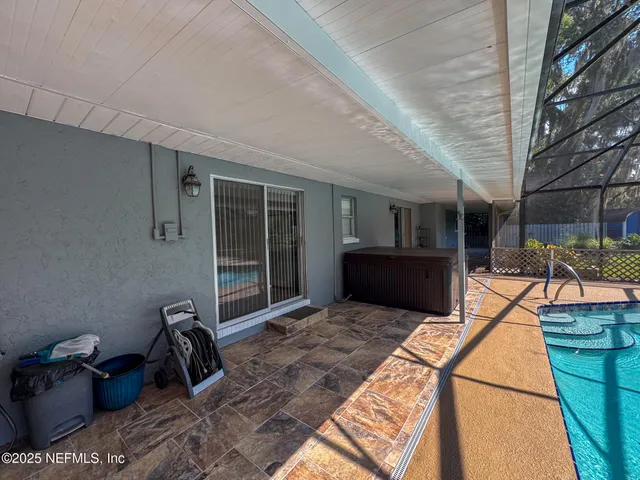a view of a house with backyard and trees