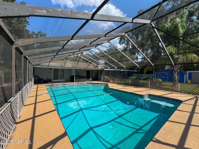 a view of outdoor space with a lounge chair and swimming pool