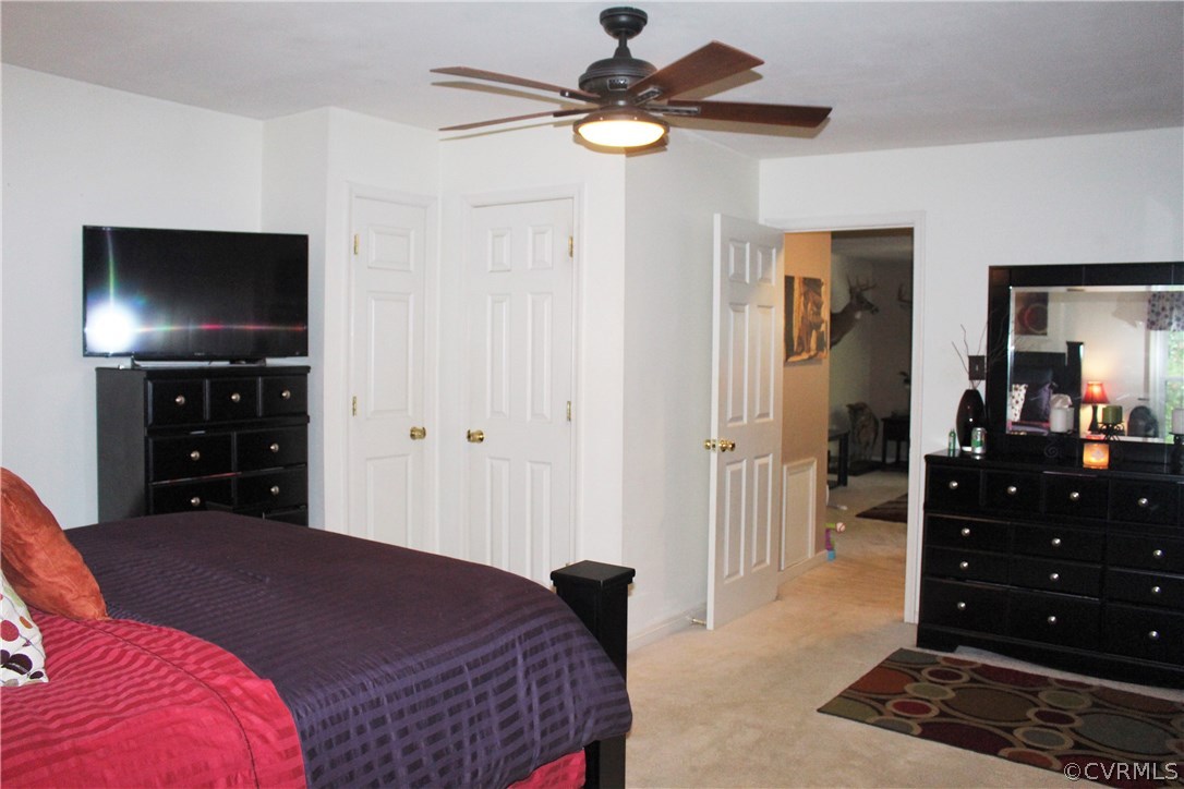 10340 North Donegal Road Chesterfield, VA 23832 - Photo 29 of 49 a bedroom with a bed and a flat tv screen on dresser