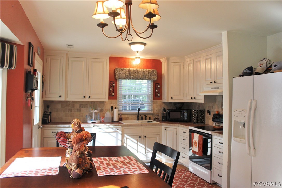 10340 North Donegal Road Chesterfield, VA 23832 - Photo 9 of 49 a kitchen with stainless steel appliances granite countertop a refrigerator a sink a stove and white cabinets