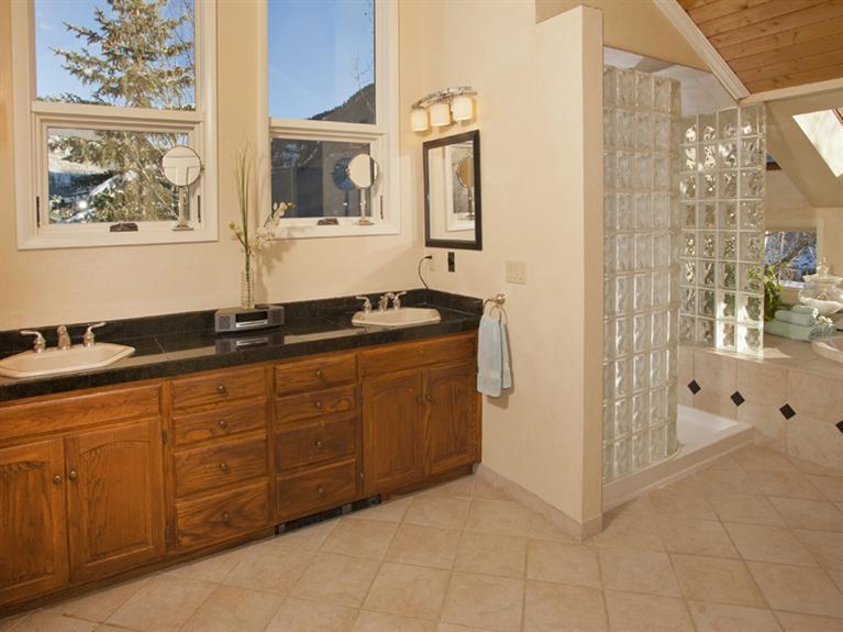 2570 Bald Mountain Road, Unit E Vail, CO 81657 - Photo 13 of 25 a spacious bathroom with a granite countertop sink a mirror and a shower