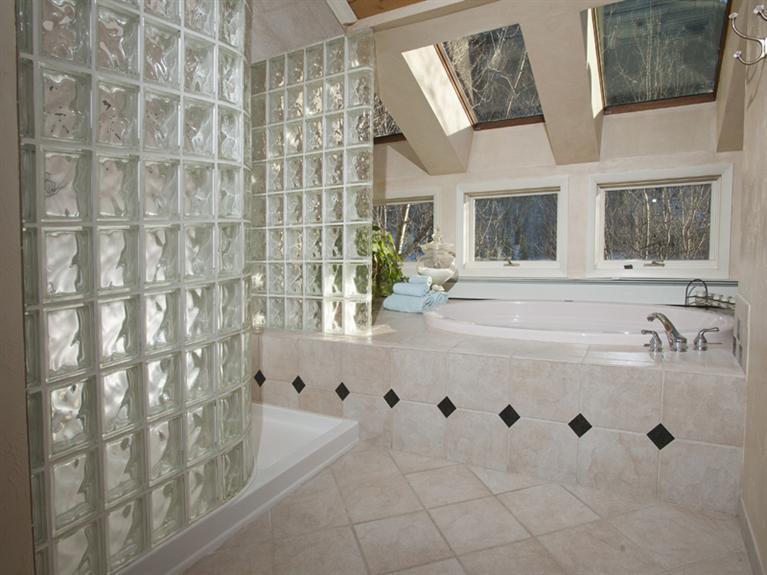 2570 Bald Mountain Road, Unit E Vail, CO 81657 - Photo 14 of 25 a bathroom with a tub sink and mirror