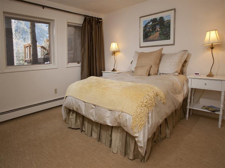 2570 Bald Mountain Road, Unit E Vail, CO 81657 - Photo 17 of 25 a bed sitting in a bedroom next to a window