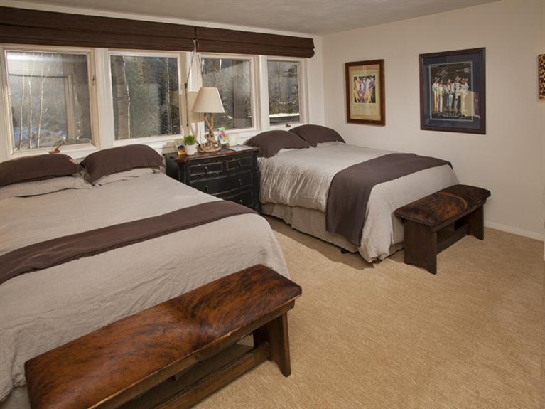 2570 Bald Mountain Road, Unit E Vail, CO 81657 - Photo 18 of 25 a bedroom with two beds and large window