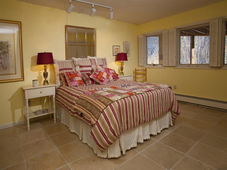 2570 Bald Mountain Road, Unit E Vail, CO 81657 - Photo 19 of 25 a bed room with a bed and windows
