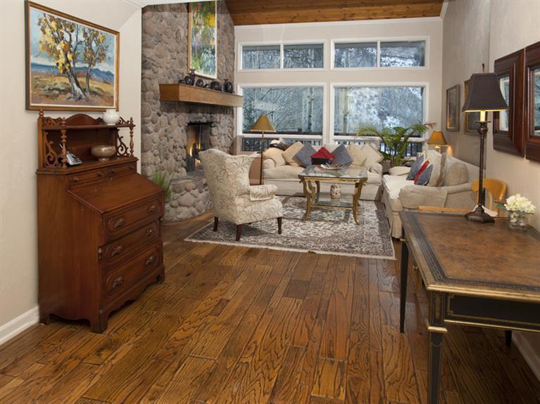 2570 Bald Mountain Road, Unit E Vail, CO 81657 - Photo 21 of 25 a living room with furniture a fireplace and a flat screen tv