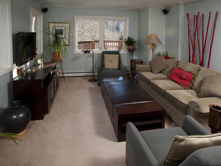 2570 Bald Mountain Road, Unit E Vail, CO 81657 - Photo 22 of 25 a living room with furniture and a flat screen tv