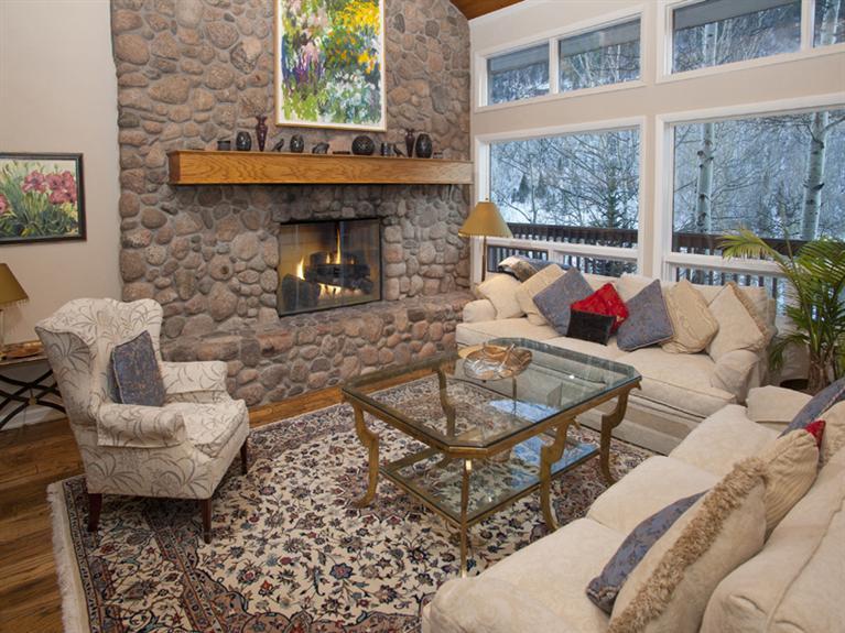 2570 Bald Mountain Road, Unit E Vail, CO 81657 - Photo 3 of 25 a living room with furniture and a fireplace
