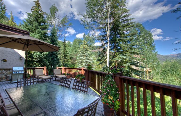 2570 Bald Mountain Road, Unit E Vail, CO 81657 - Photo 6 of 25 a view of swimming pool with seating area and trees in the background