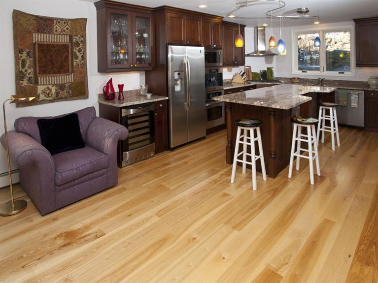 2570 Bald Mountain Road, Unit E Vail, CO 81657 - Photo 10 of 25 a kitchen with stainless steel appliances granite countertop a refrigerator a stove top oven and a dining table with granite countertops