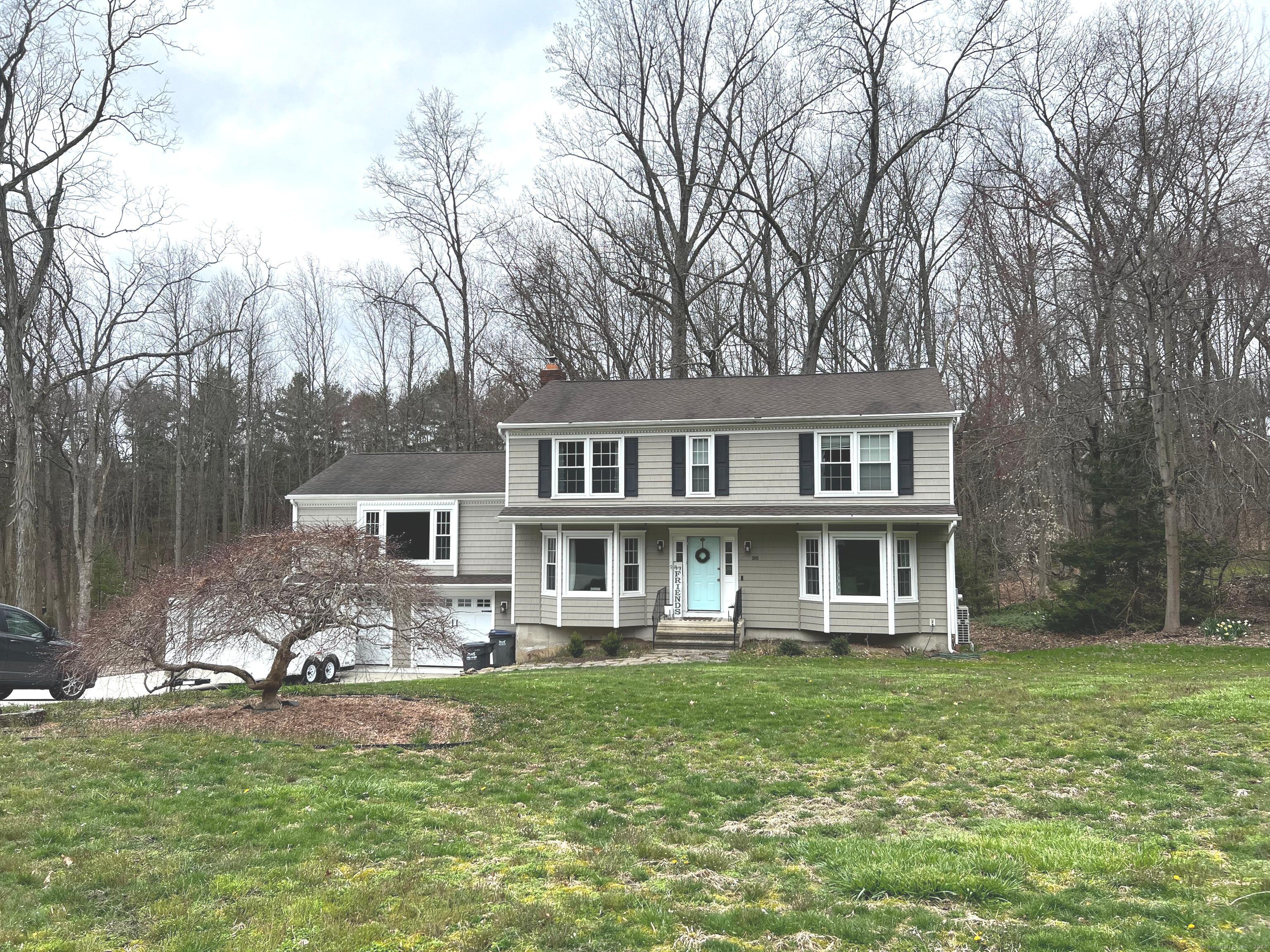 98 Old Hollow Road Trumbull, CT 06611 - Photo 1 of 1 a front view of a house with a yard table and chairs