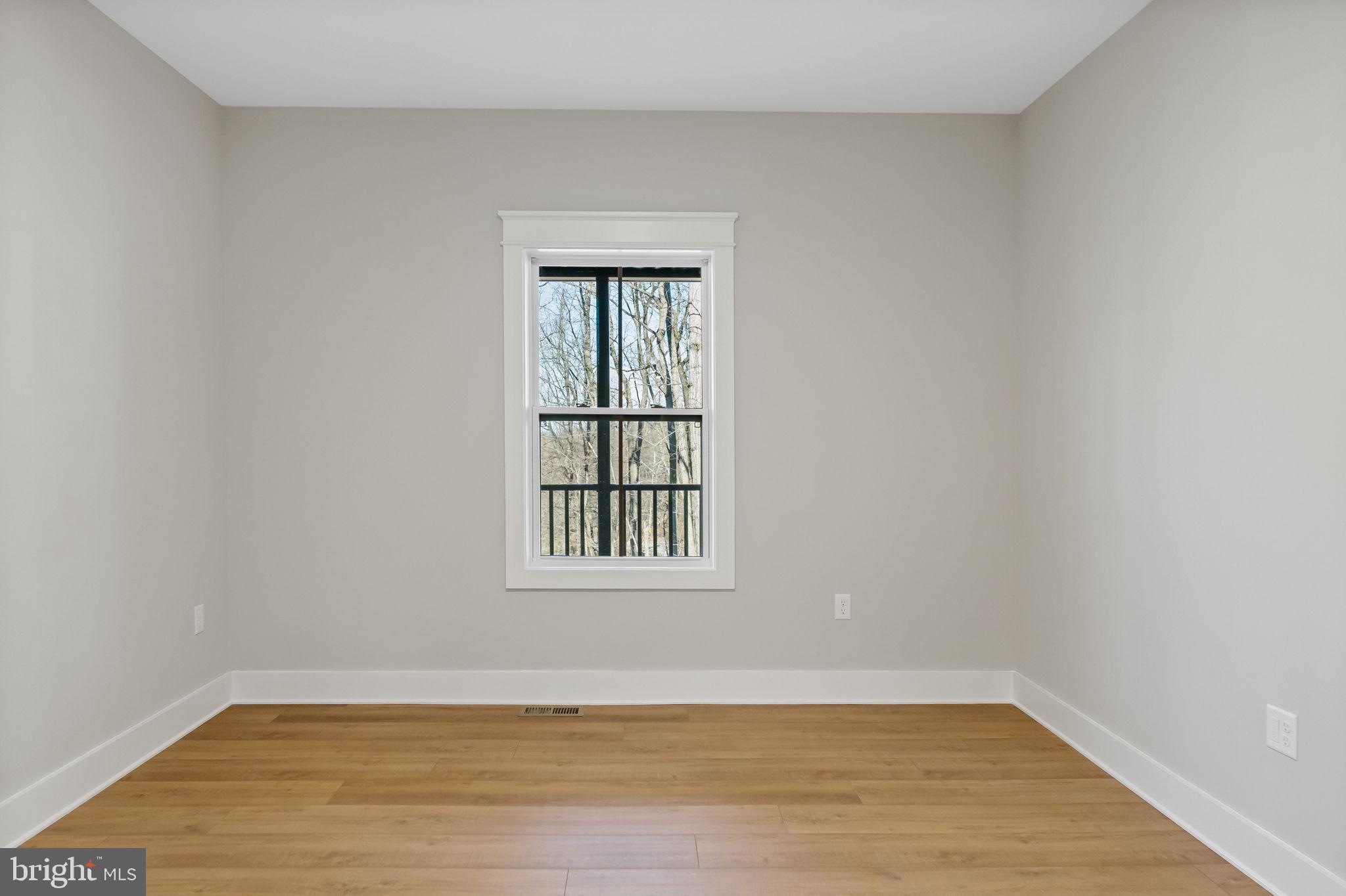 321 Mistletoe Lane Shepherdstown, WV 25443 - Photo 20 of 58 a view of an empty room with wooden floor and a window