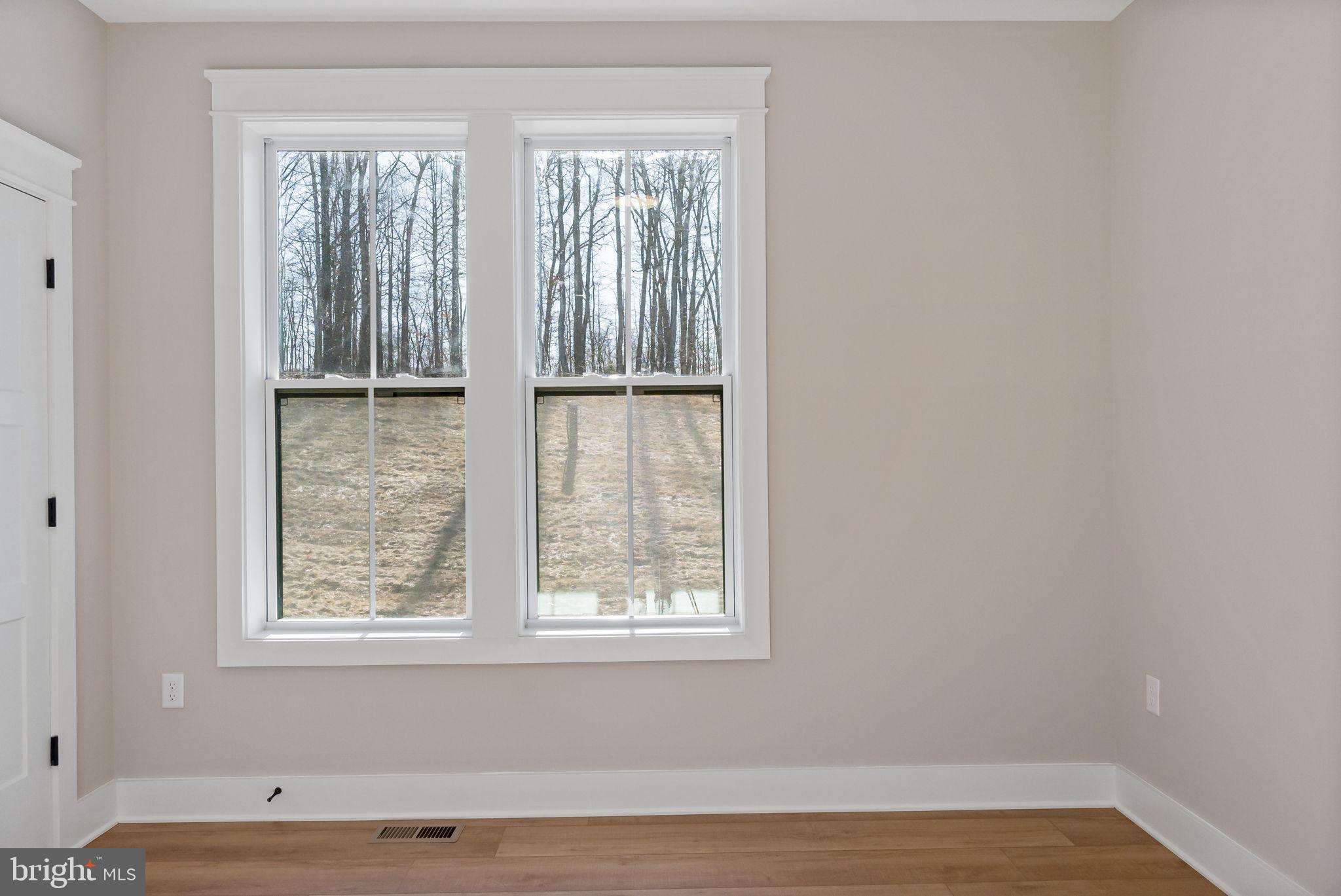 321 Mistletoe Lane Shepherdstown, WV 25443 - Photo 30 of 58 an empty room with wooden floor and windows