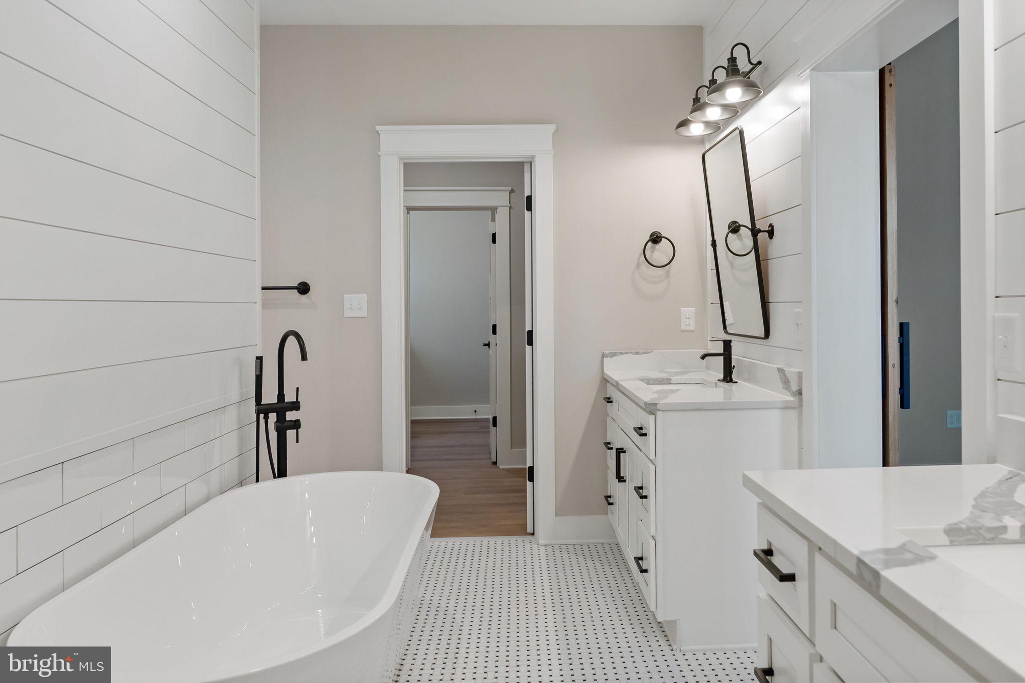 321 Mistletoe Lane Shepherdstown, WV 25443 - Photo 39 of 58 a bathroom with a sink a mirror and a bathtub