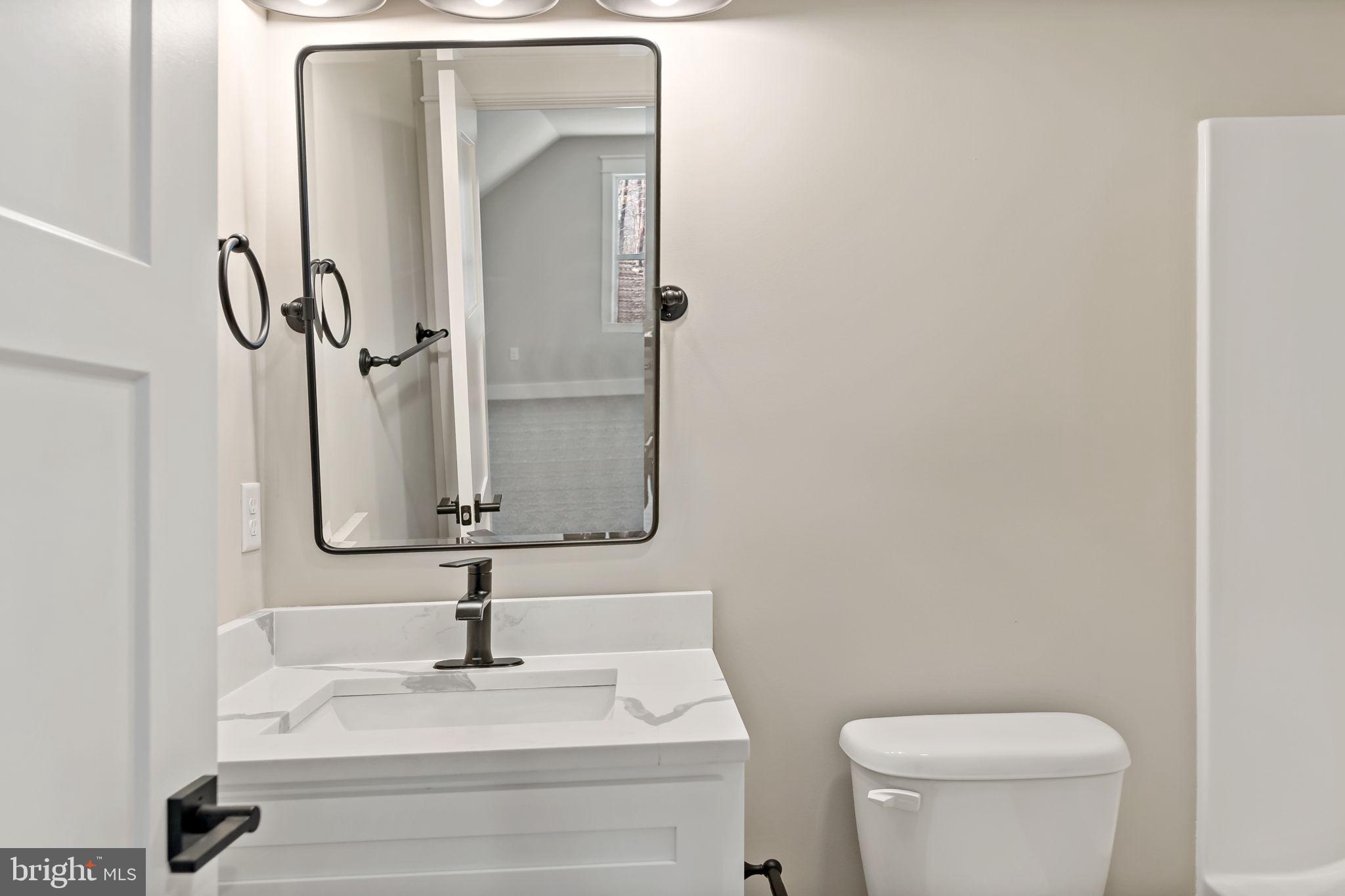 321 Mistletoe Lane Shepherdstown, WV 25443 - Photo 50 of 57 a bathroom with a toilet sink and mirror
