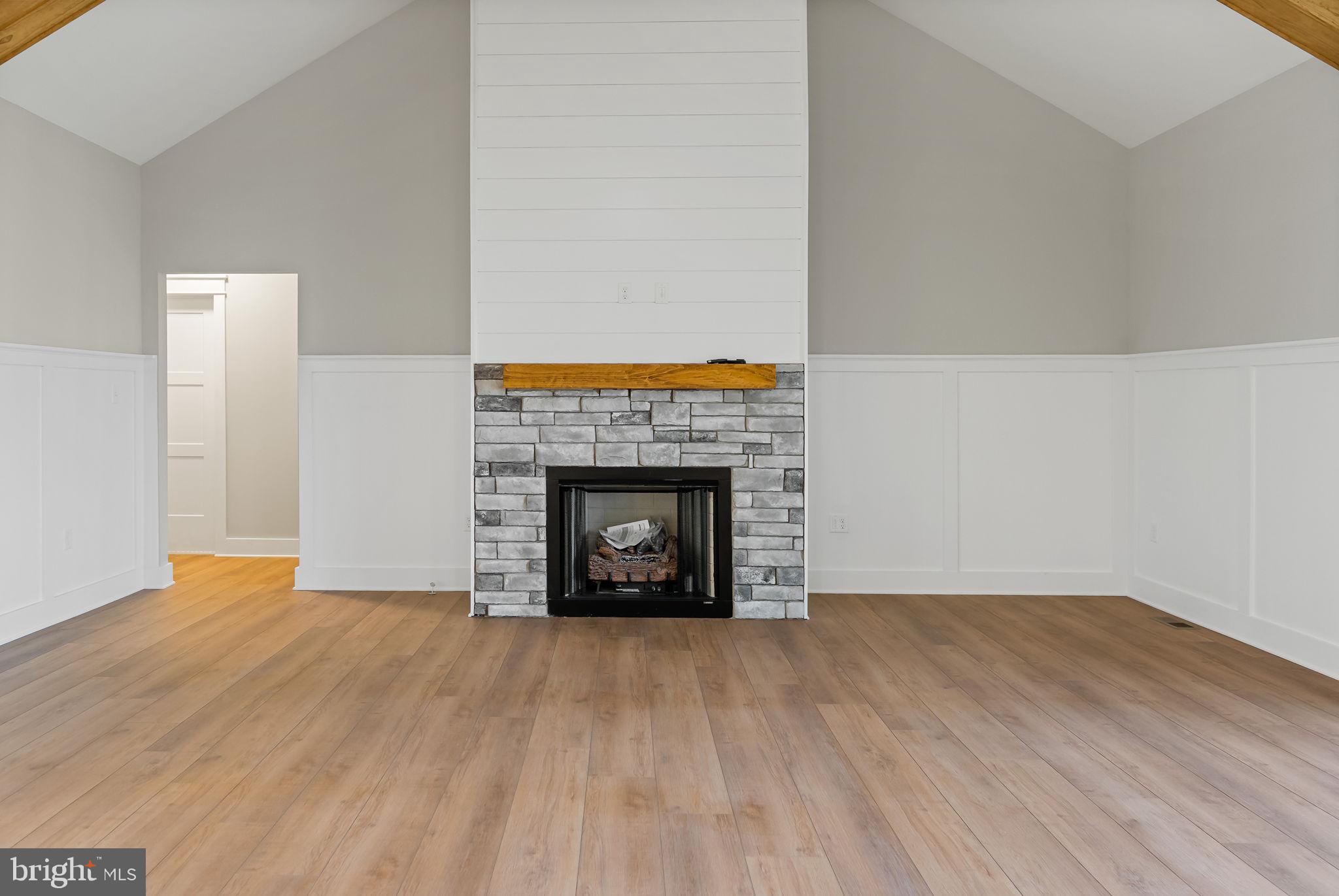 321 Mistletoe Lane Shepherdstown, WV 25443 - Photo 7 of 58 a view of an empty room with wooden floor fire place