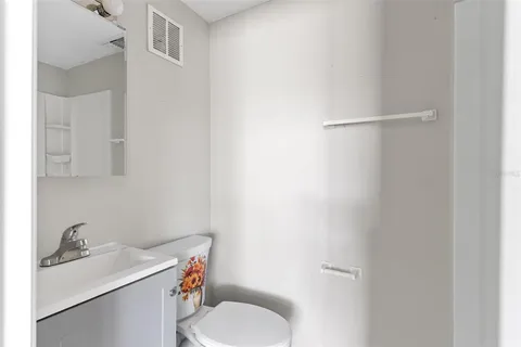a bathroom with a sink toilet and a mirror