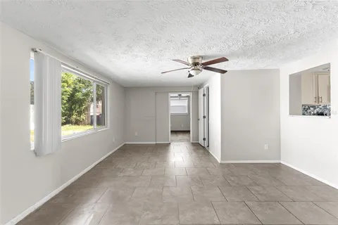 a view of a hallway with windows and chandelier