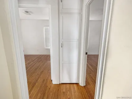 a view of a hallway with wooden floor