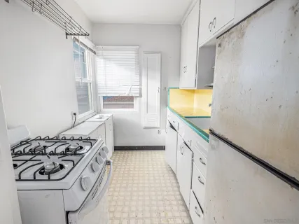 a kitchen with stainless steel appliances a stove a sink and a refrigerator