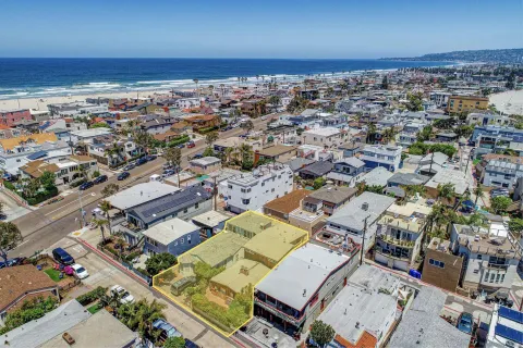 an aerial view of a city with ocean view