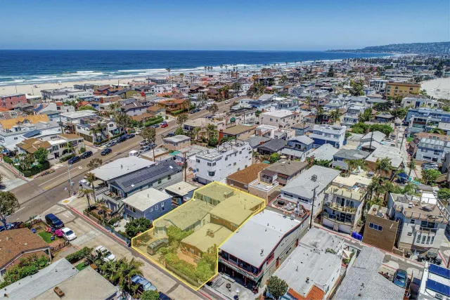 an aerial view of a city with ocean view