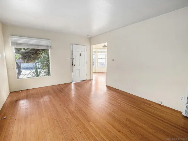 a view of an empty room and wooden floor