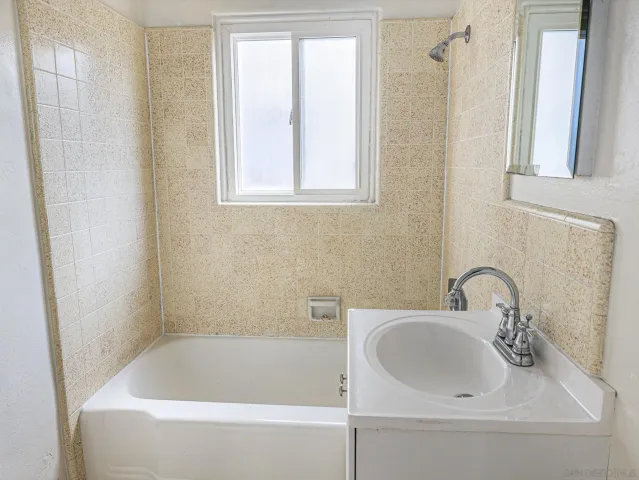 a white bath tub sitting next to a white sink