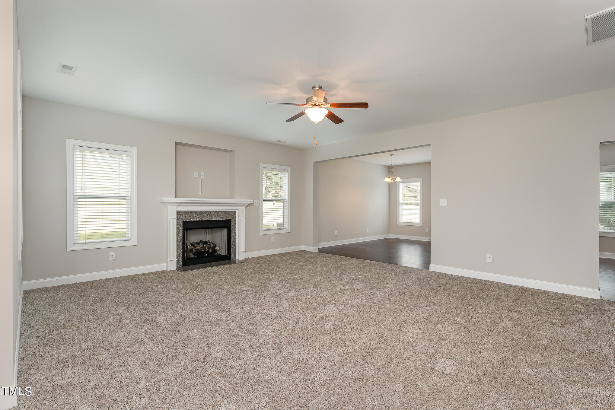 117 Celestial Drive Garner, NC 27529 - Photo 2 of 15 a view of empty room with fireplace and fan