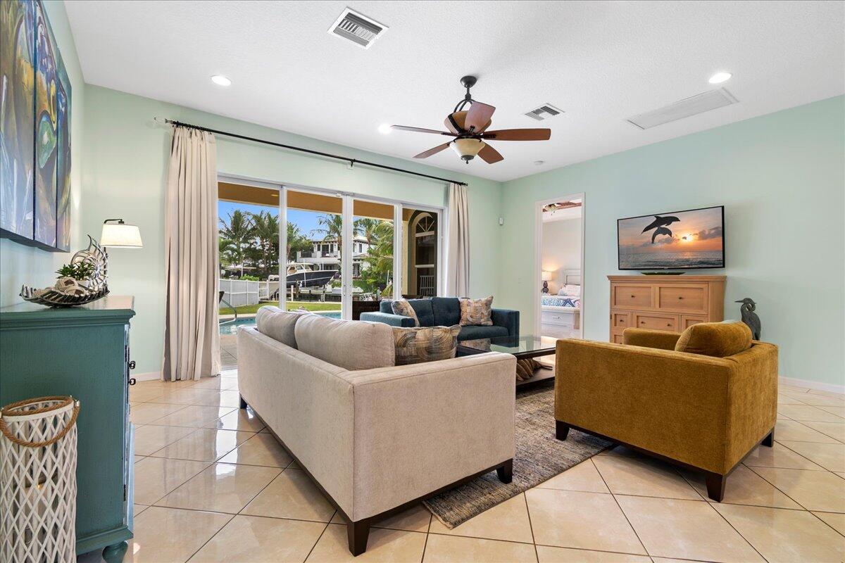 72 Waterway Road Jupiter, FL 33469 - Photo 15 of 57 a living room with furniture and a flat screen tv