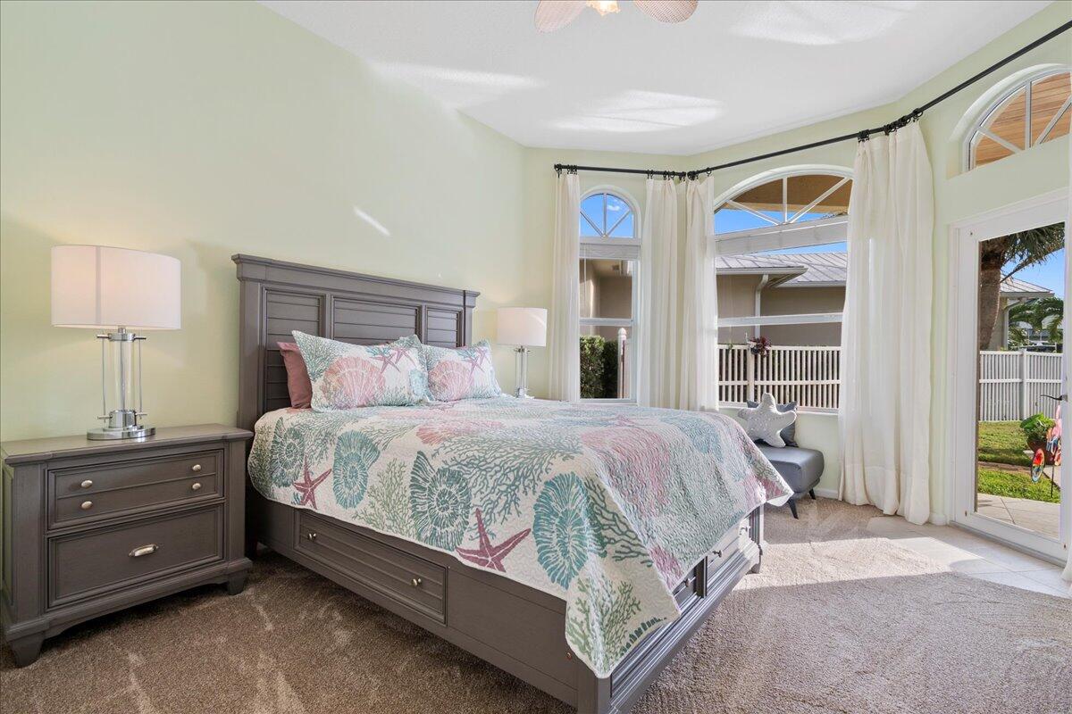 72 Waterway Road Jupiter, FL 33469 - Photo 21 of 57 a bedroom with a bed and a window