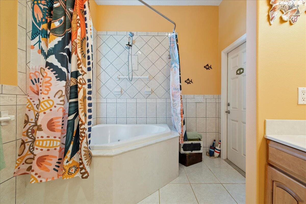 72 Waterway Road Jupiter, FL 33469 - Photo 24 of 57 a bathroom with a bathtub and shower