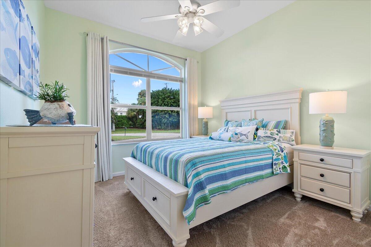 72 Waterway Road Jupiter, FL 33469 - Photo 26 of 57 a bedroom with a bed and a chandelier