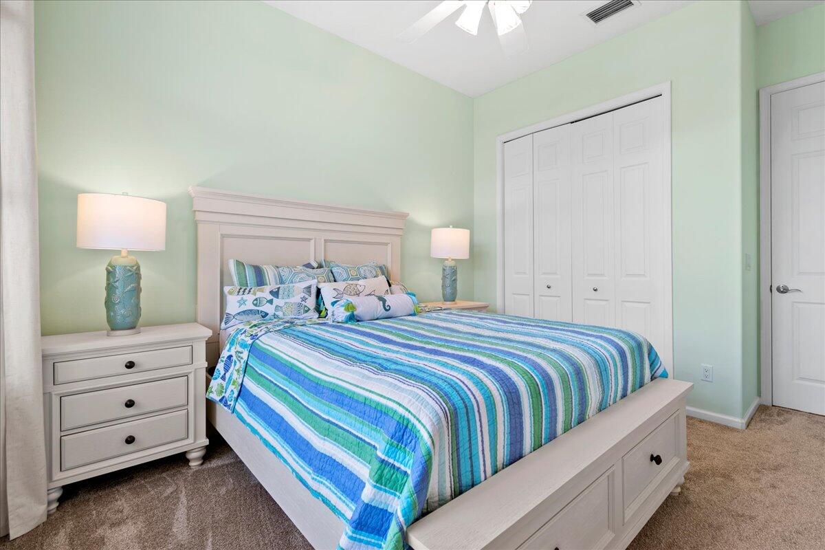 72 Waterway Road Jupiter, FL 33469 - Photo 27 of 57 a bedroom with a bed and a dresser in it