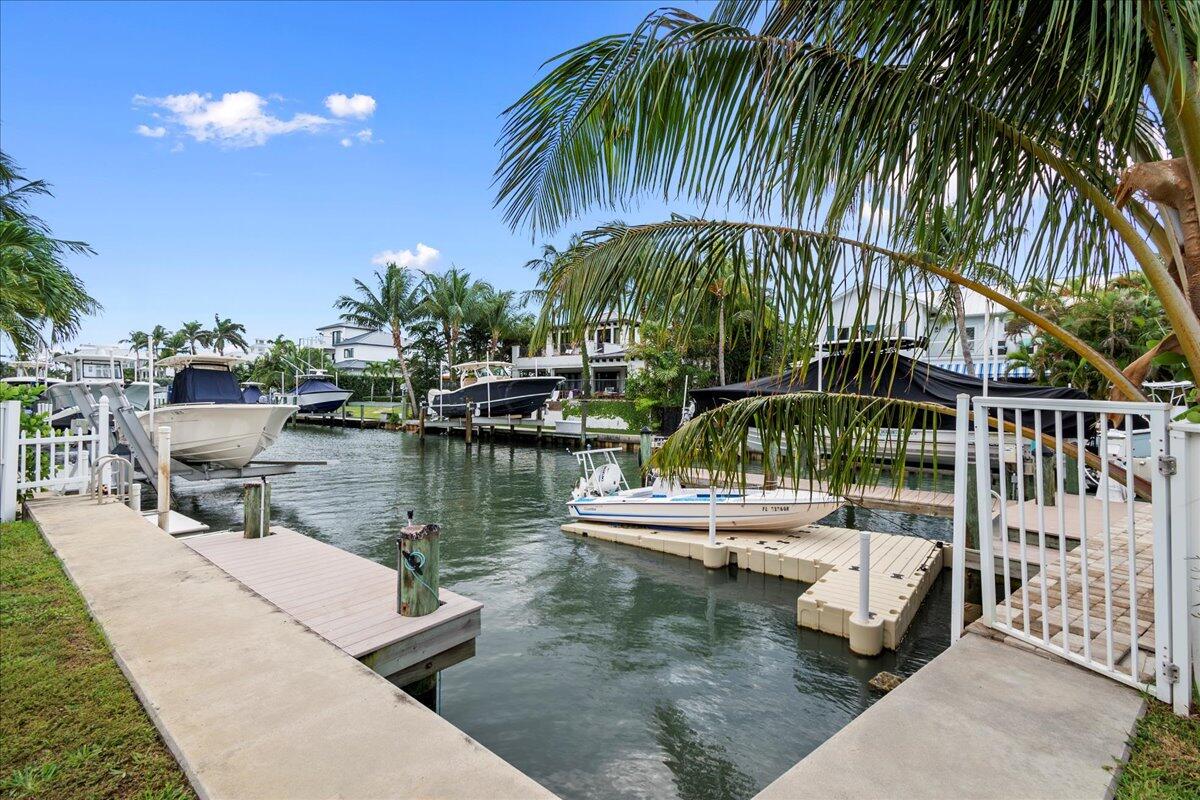 72 Waterway Road Jupiter, FL 33469 - Photo 3 of 57 a view of swimming pool with a table and chairs