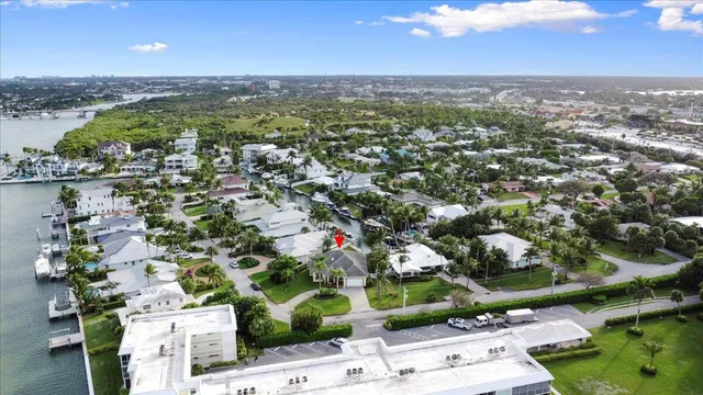an aerial view of a city with lots of residential buildings lake and ocean view