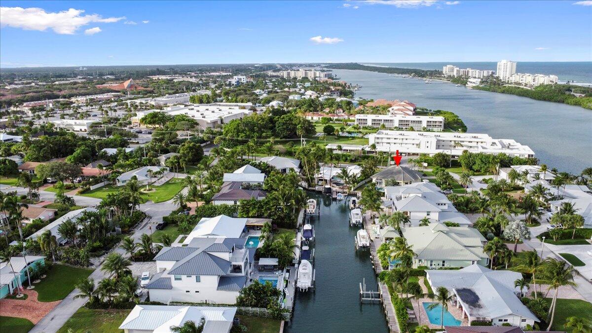 72 Waterway Road Jupiter, FL 33469 - Photo 40 of 57 an aerial view of a city with lots of residential buildings ocean and mountain view in back