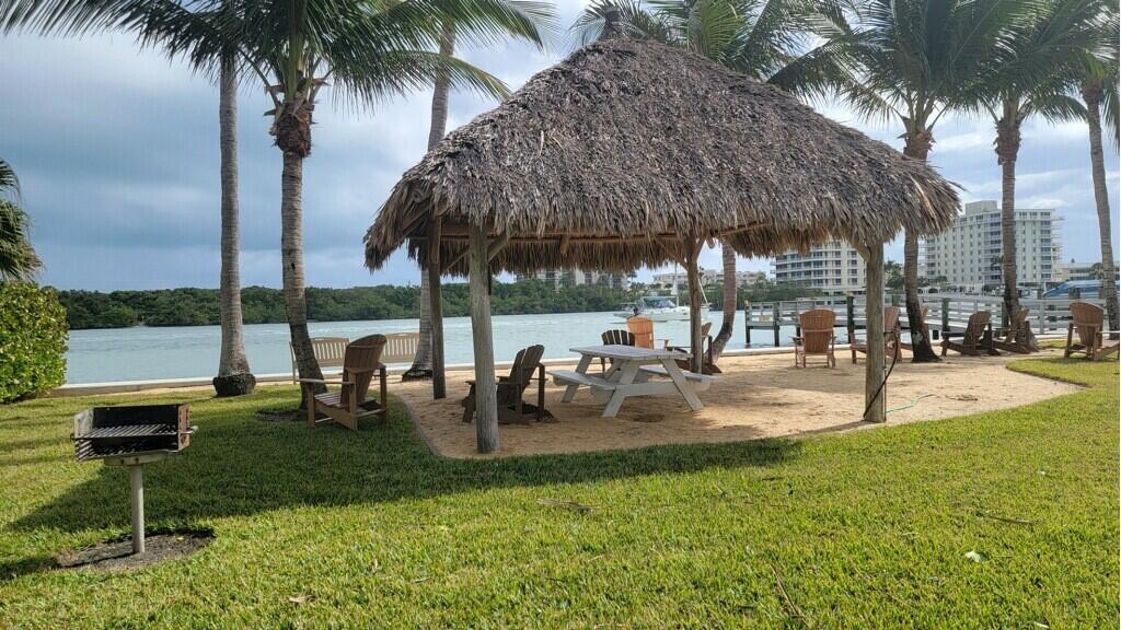 72 Waterway Road Jupiter, FL 33469 - Photo 55 of 57 a view of a swimming pool with a table and chairs