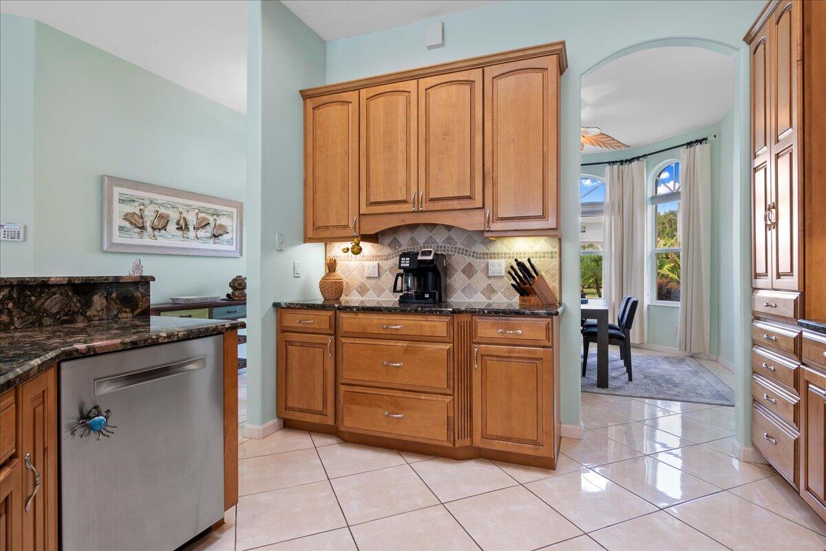 72 Waterway Road Jupiter, FL 33469 - Photo 6 of 57 a kitchen with stainless steel appliances granite countertop a stove a sink and a refrigerator